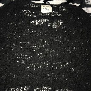 Loose knitted black throw over.